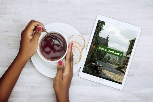 Person holding a cup of tea with a tablet displaying 'Advanced Java' on a light surface.