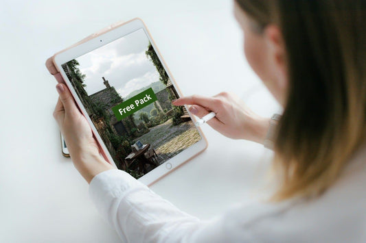 Person holding a tablet with a Java PDF course 'Free Pack' text on the screen.