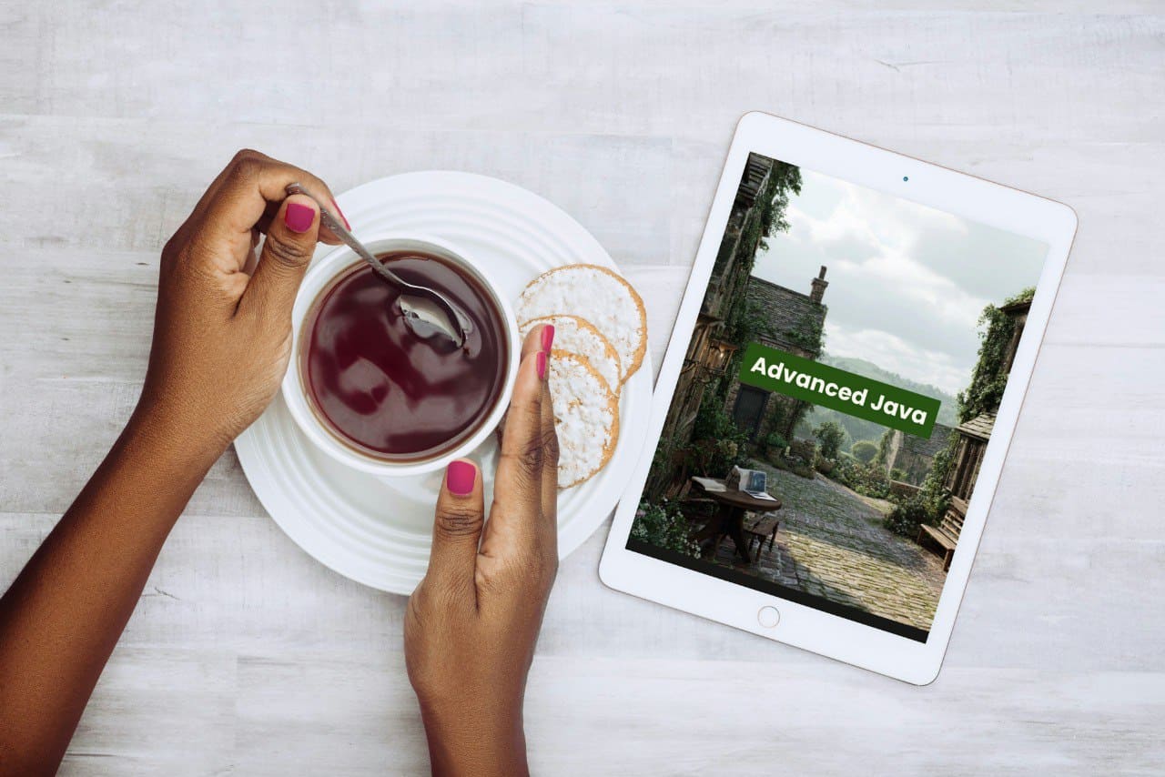 Person holding a cup of tea with a tablet displaying 'Advanced Java' on a light surface.