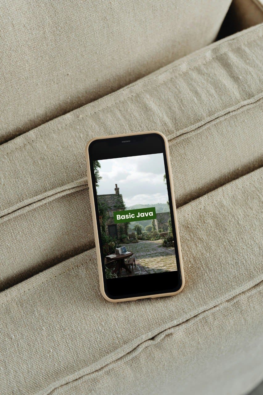 Phone displaying a 'Basic Java' PDF course on a beige couch