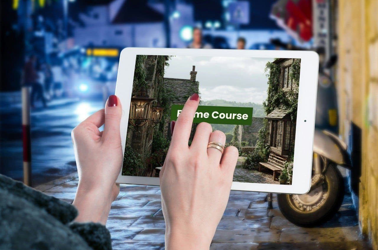 Person holding a tablet with a screen displaying a 'Frame Course' image in a garage setting.