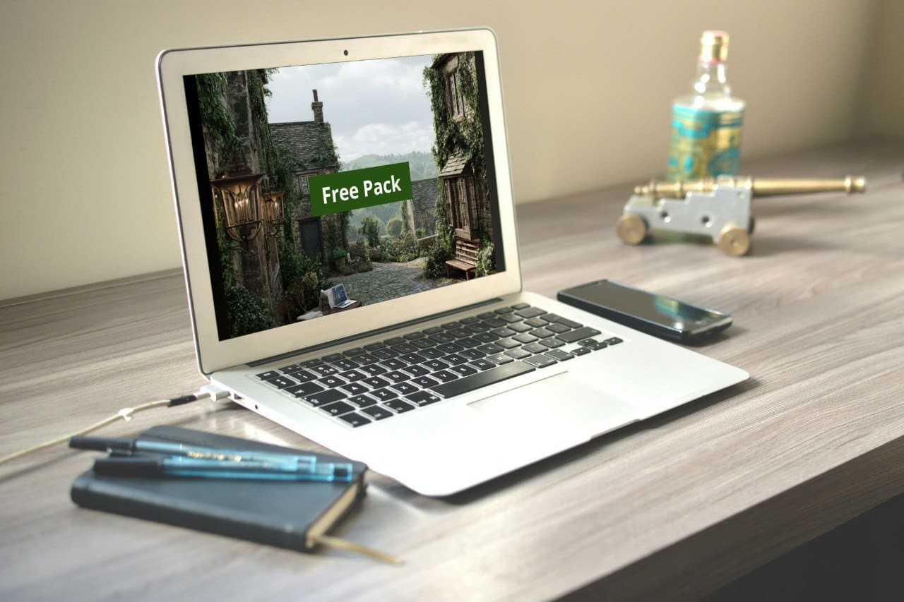 Laptop on a desk with a Java PDF course 'Free Pack', notebook, phone, and bottle in the background.
